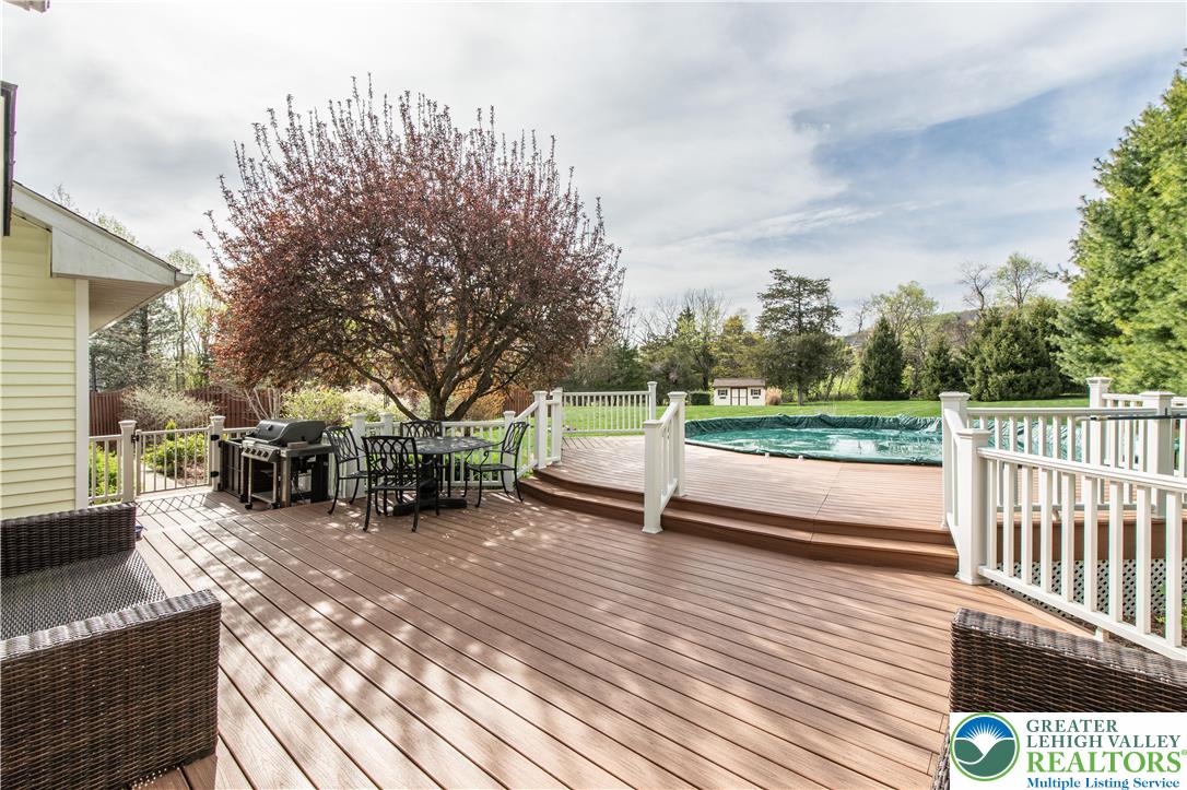 540 Royal Manor Road Easton, PA 18042 - Photo 19 of 64 a view of a roof deck with table and chairs and wooden fence