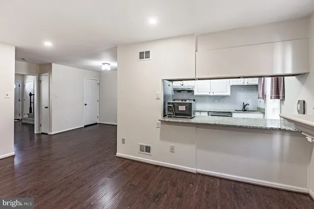 a kitchen with stainless steel appliances a refrigerator and microwave