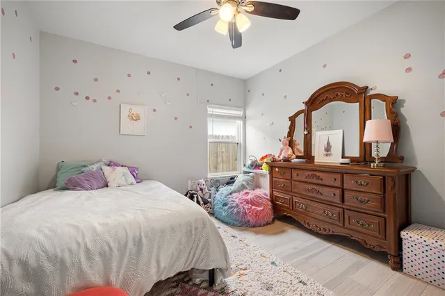a bedroom with two beds and a chandelier