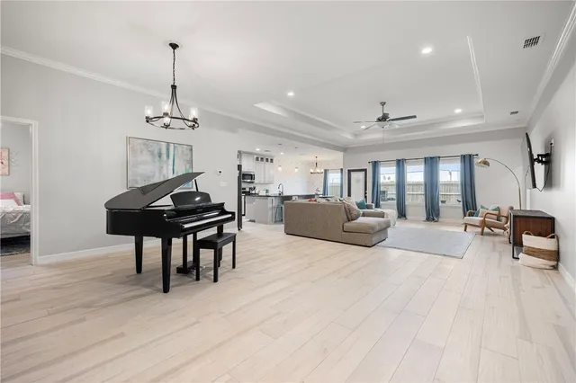a living room with furniture and a wooden floor