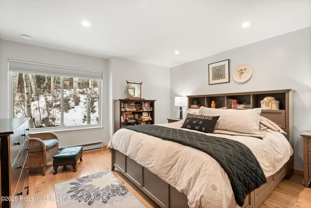 a bathroom with a granite countertop sink vanity mirror and toilet