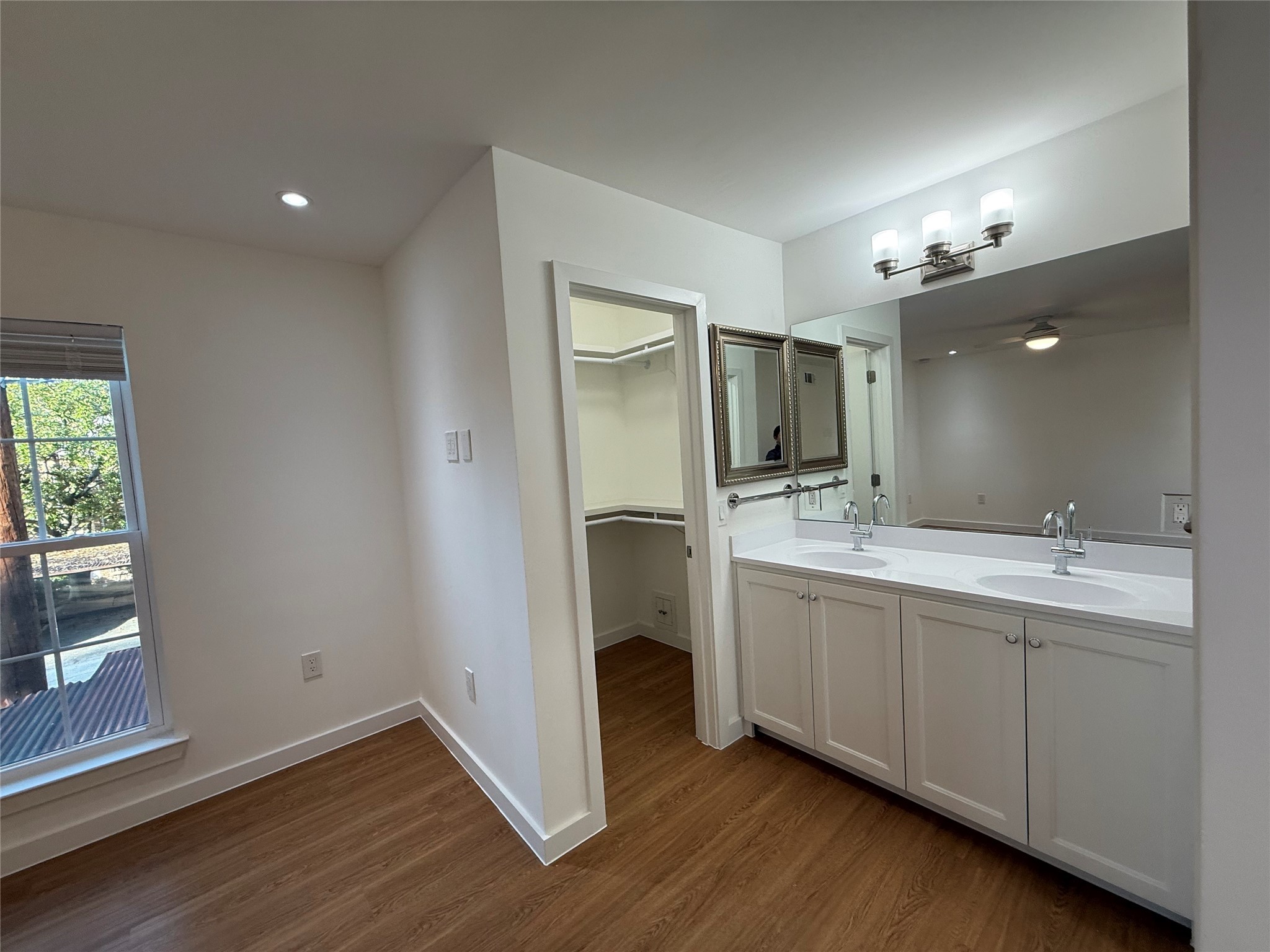 3400 Timmons Lane, Unit 52 56 Houston, TX 77027 - Photo 13 of 40 a bathroom with a double vanity sink and a mirror