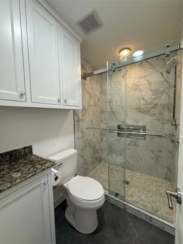 a bathroom with a toilet sink and shower