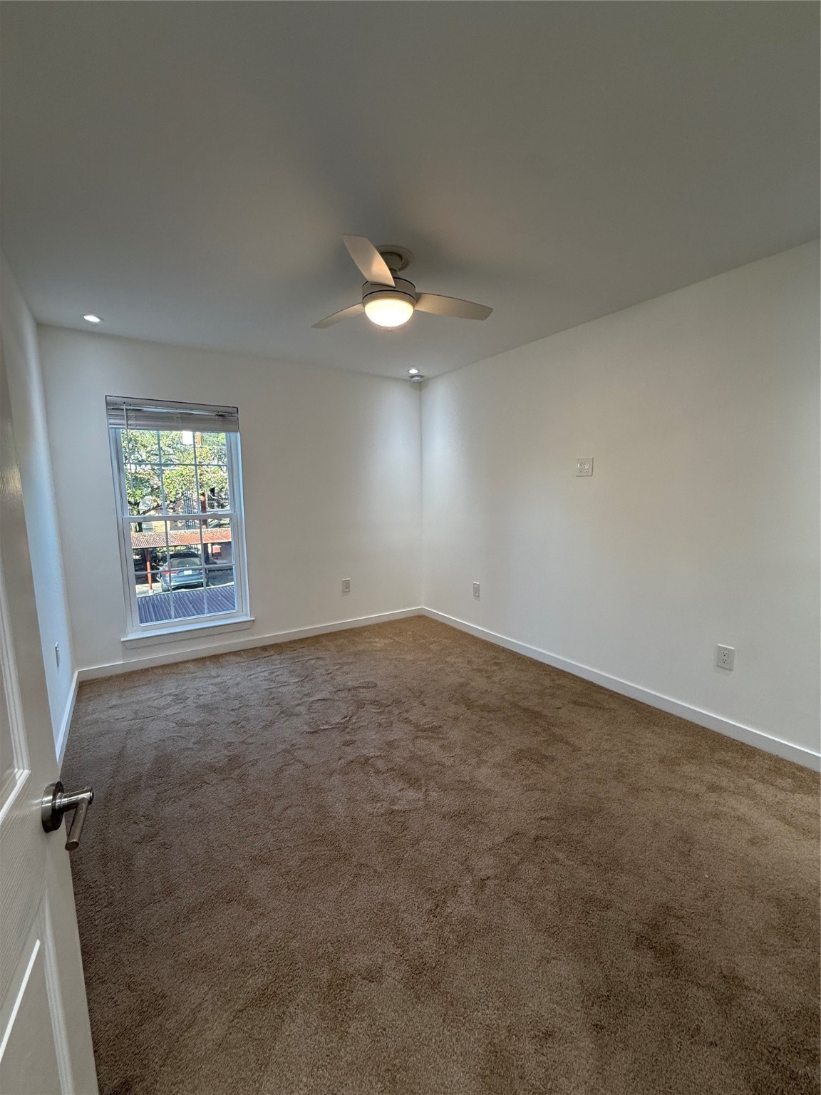 3400 Timmons Lane, Unit 52 56 Houston, TX 77027 - Photo 24 of 40 an empty room with a chandelier fan and windows
