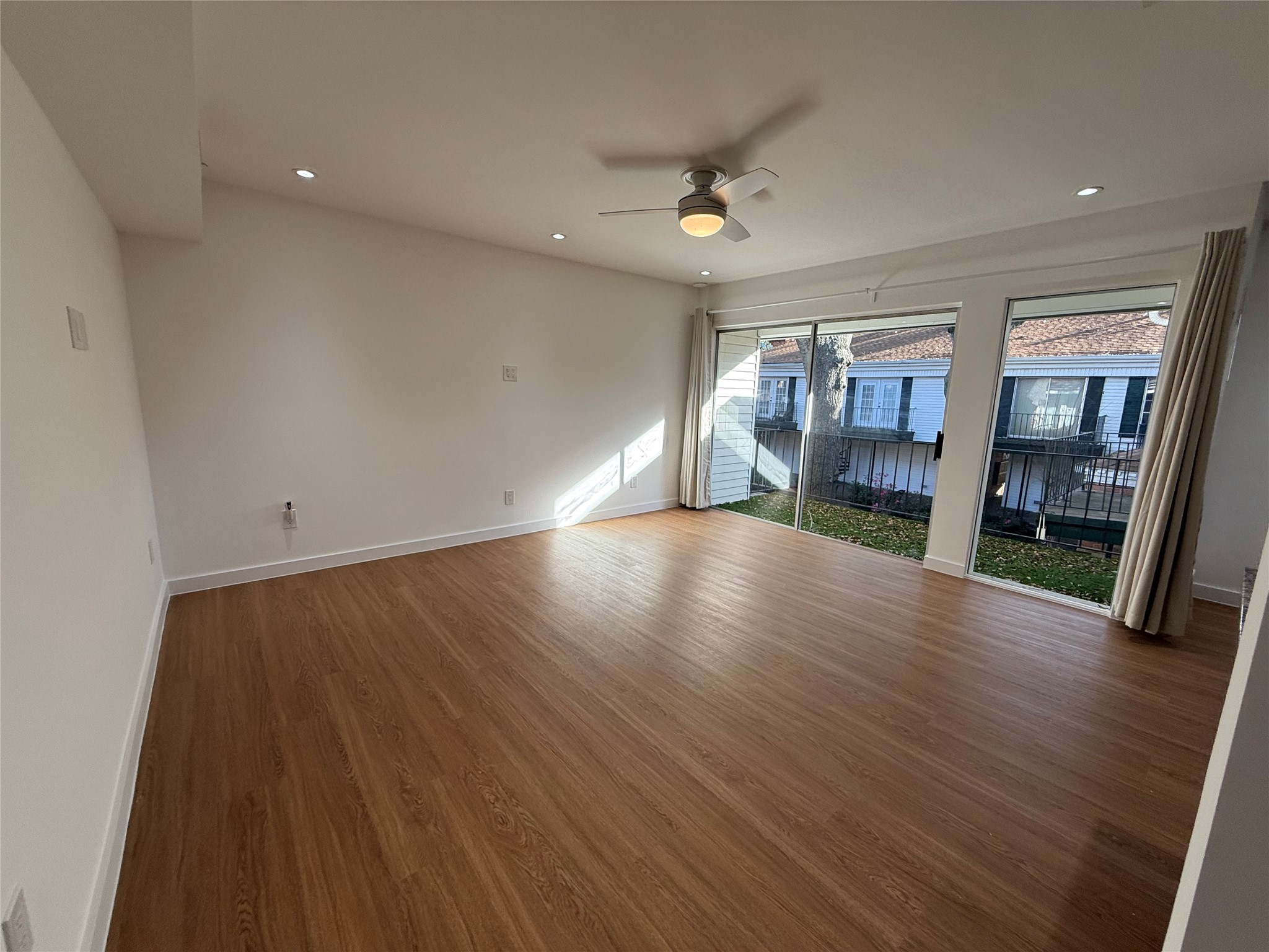 3400 Timmons Lane, Unit 52 56 Houston, TX 77027 - Photo 28 of 40 an empty room with wooden floor and windows