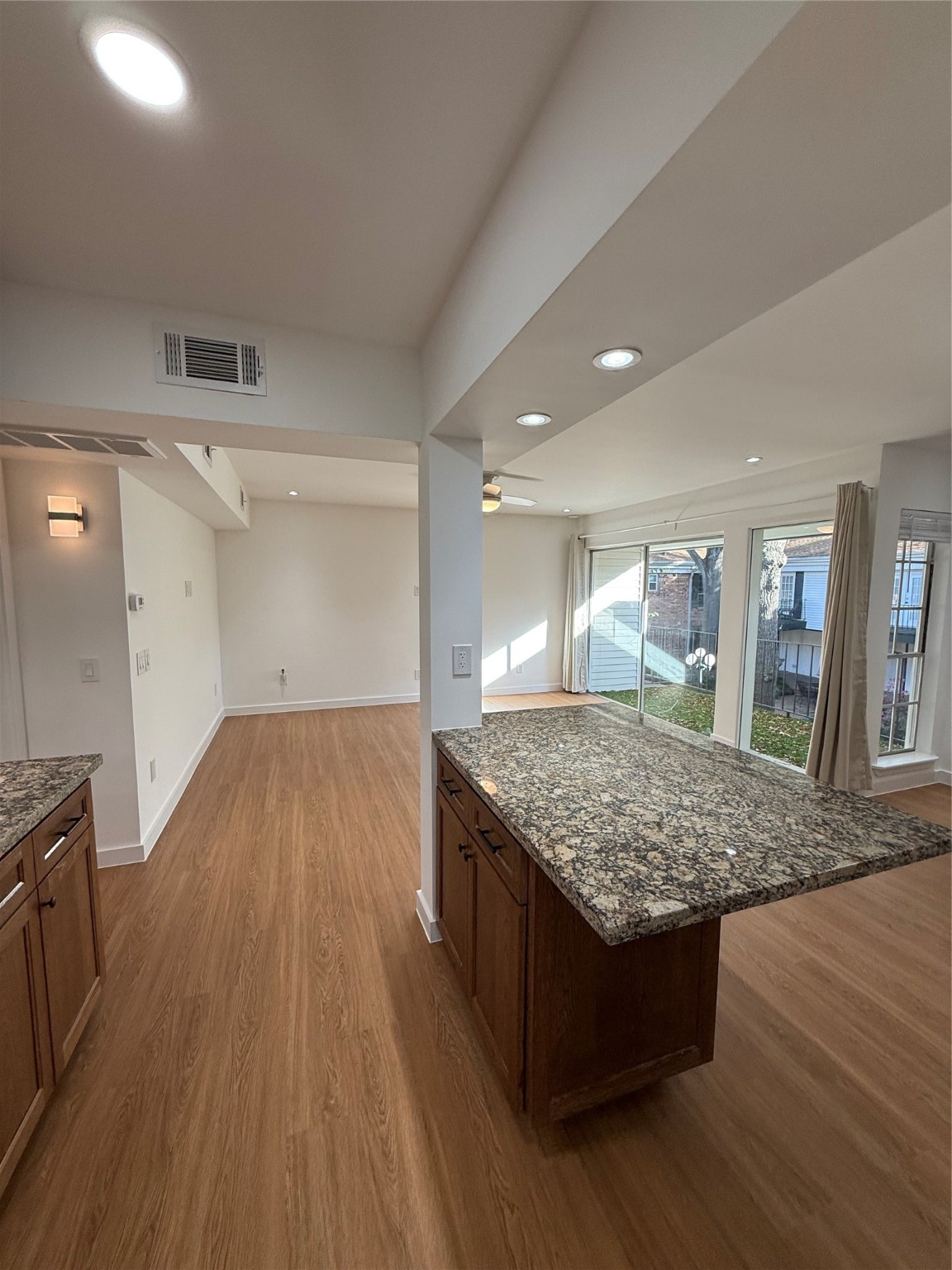 3400 Timmons Lane, Unit 52 56 Houston, TX 77027 - Photo 29 of 40 a kitchen with stainless steel appliances granite countertop wooden cabinets a sink dishwasher and a wooden floor