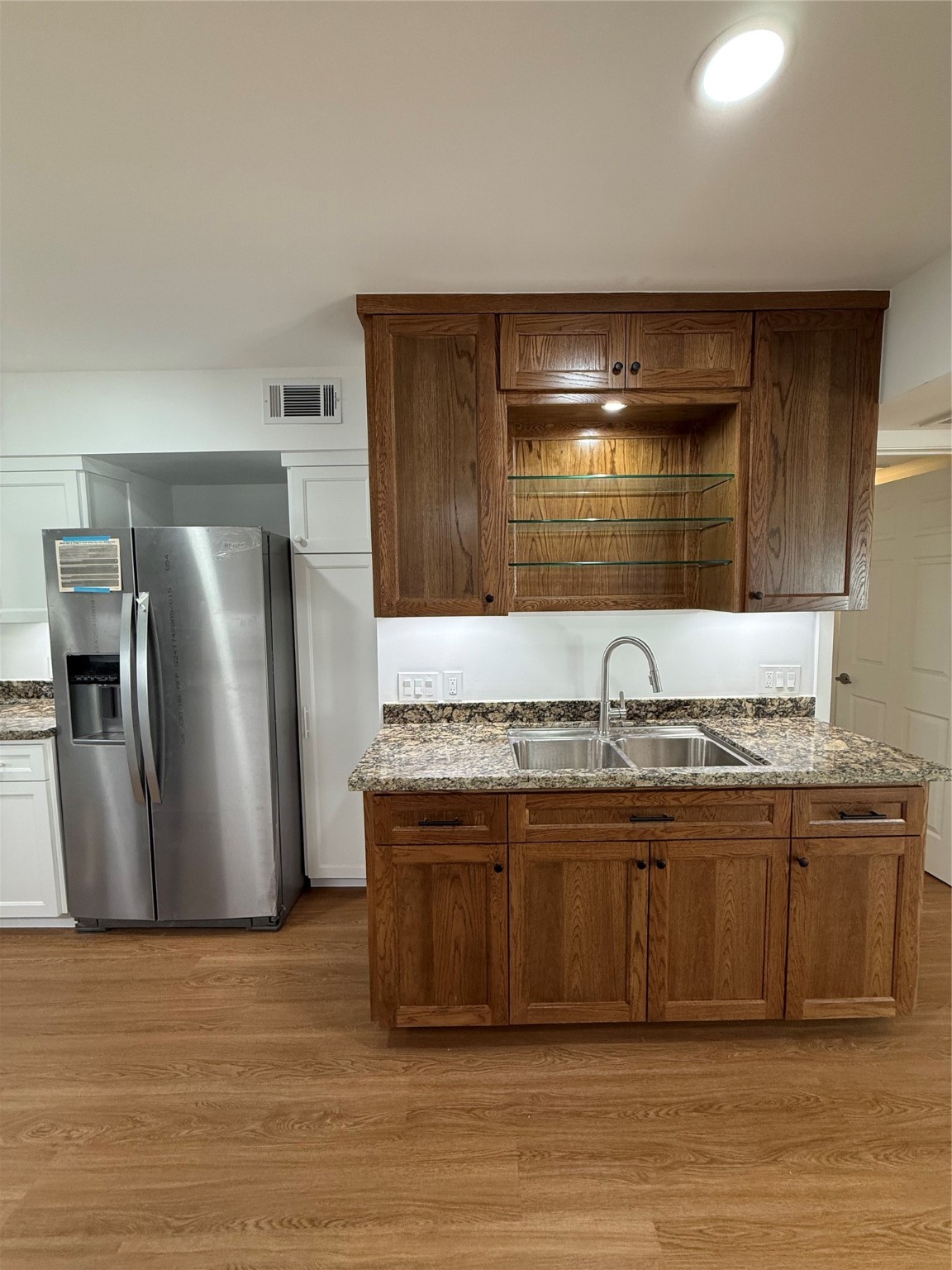 3400 Timmons Lane, Unit 52 56 Houston, TX 77027 - Photo 31 of 40 a kitchen with stainless steel appliances granite countertop a sink and a refrigerator
