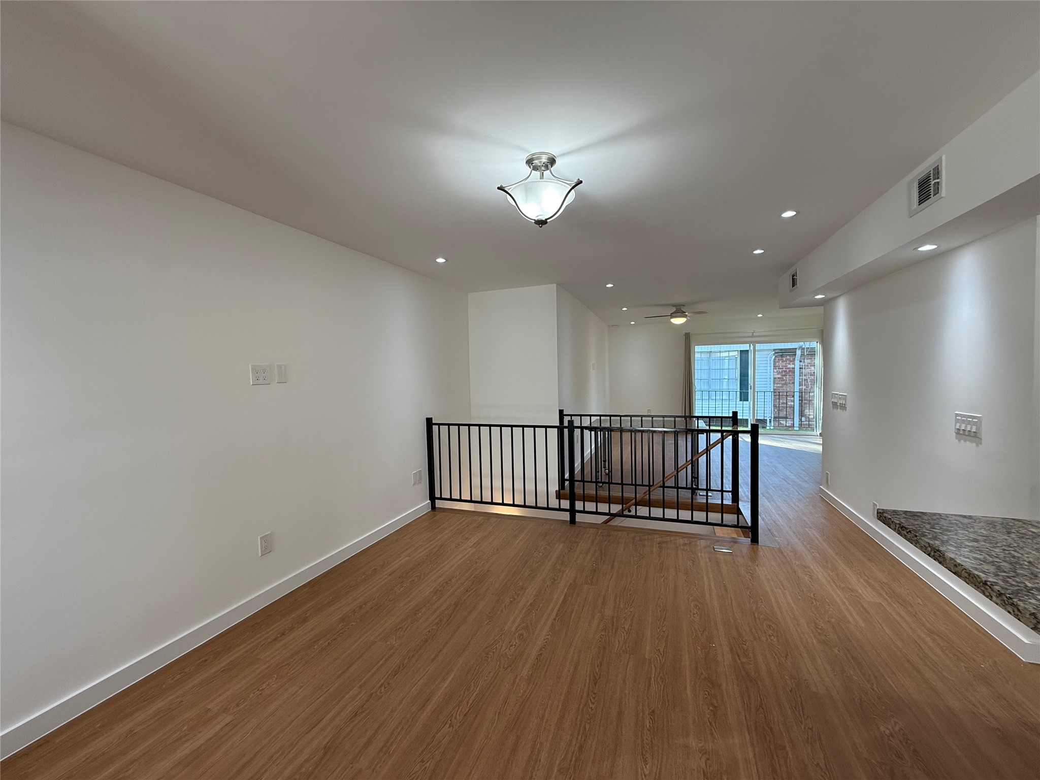 3400 Timmons Lane, Unit 52 56 Houston, TX 77027 - Photo 39 of 40 a view of a hallway with wooden floor