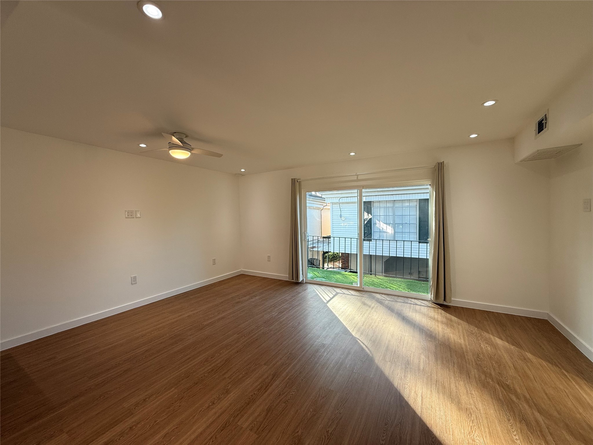 3400 Timmons Lane, Unit 52 56 Houston, TX 77027 - Photo 8 of 40 an empty room with wooden floor and windows