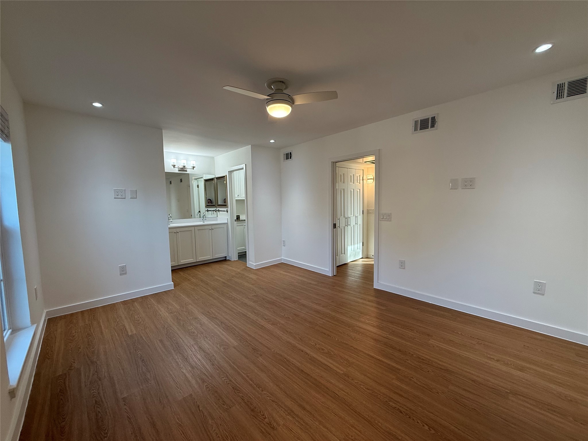 3400 Timmons Lane, Unit 52 56 Houston, TX 77027 - Photo 9 of 40 an empty room with wooden floor and windows
