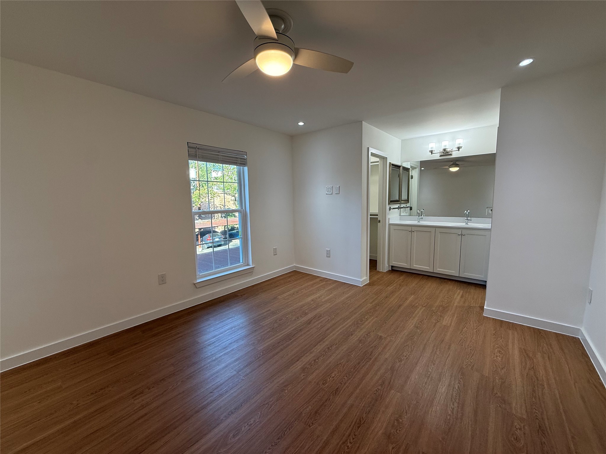 3400 Timmons Lane, Unit 52 56 Houston, TX 77027 - Photo 10 of 40 an empty room with wooden floor and windows