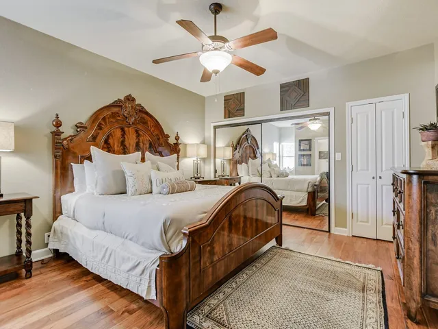 a en suite bathroom with a granite countertop sink a mirror and shower