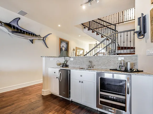 a kitchen with a sink cabinets and wooden floor