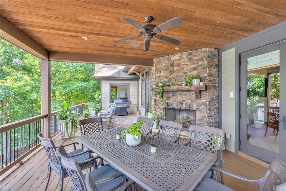 256 Talton Road Six Mile, SC 29682 - Photo 23 of 50 Rich wood plank ceilings and a massive stone fireplace elevate this outdoor living area.