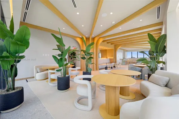 a lobby with furniture and potted plant