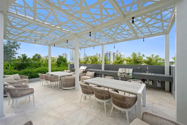 a outdoor space with lots of tables a chairs and plants