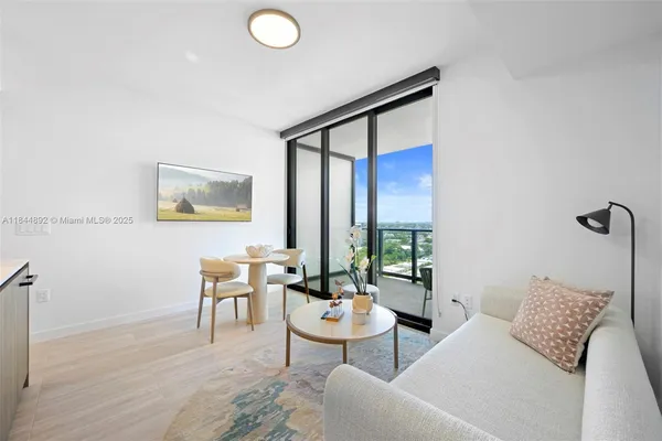 a living room with furniture and a large window