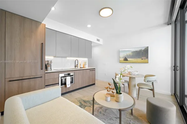 a living room with furniture and a dining table