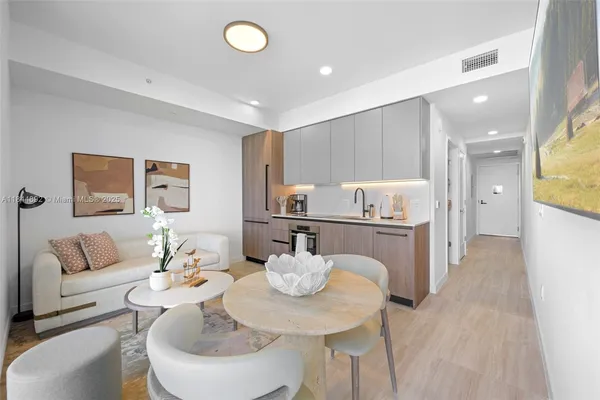 a view of a dining room with furniture and a kitchen