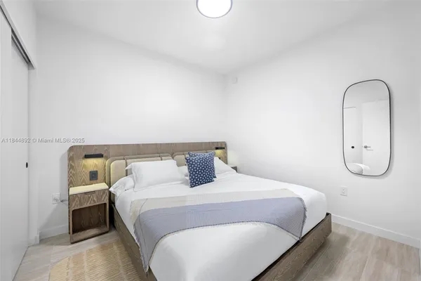 a bedroom with a bed and a painting on the wall