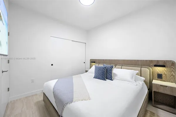 a bedroom with a bed and a night stand