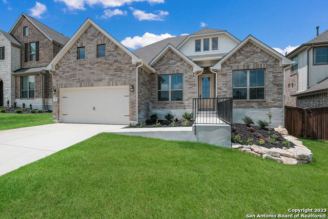 a front view of a house with a garden and patio