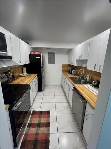a kitchen with granite countertop a stove and a refrigerator