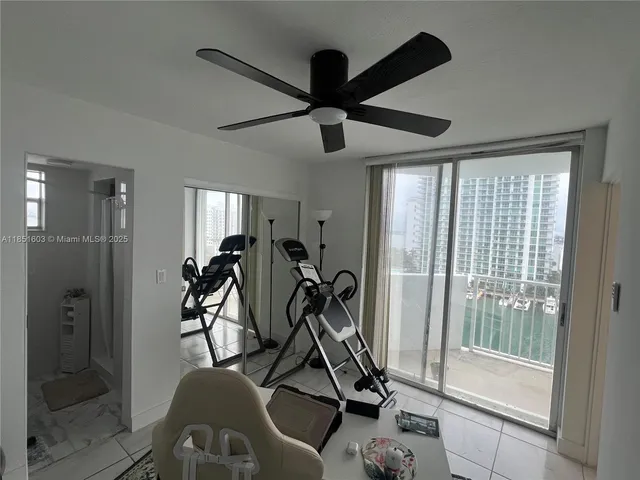 a room with gym equipment and a glass door shower