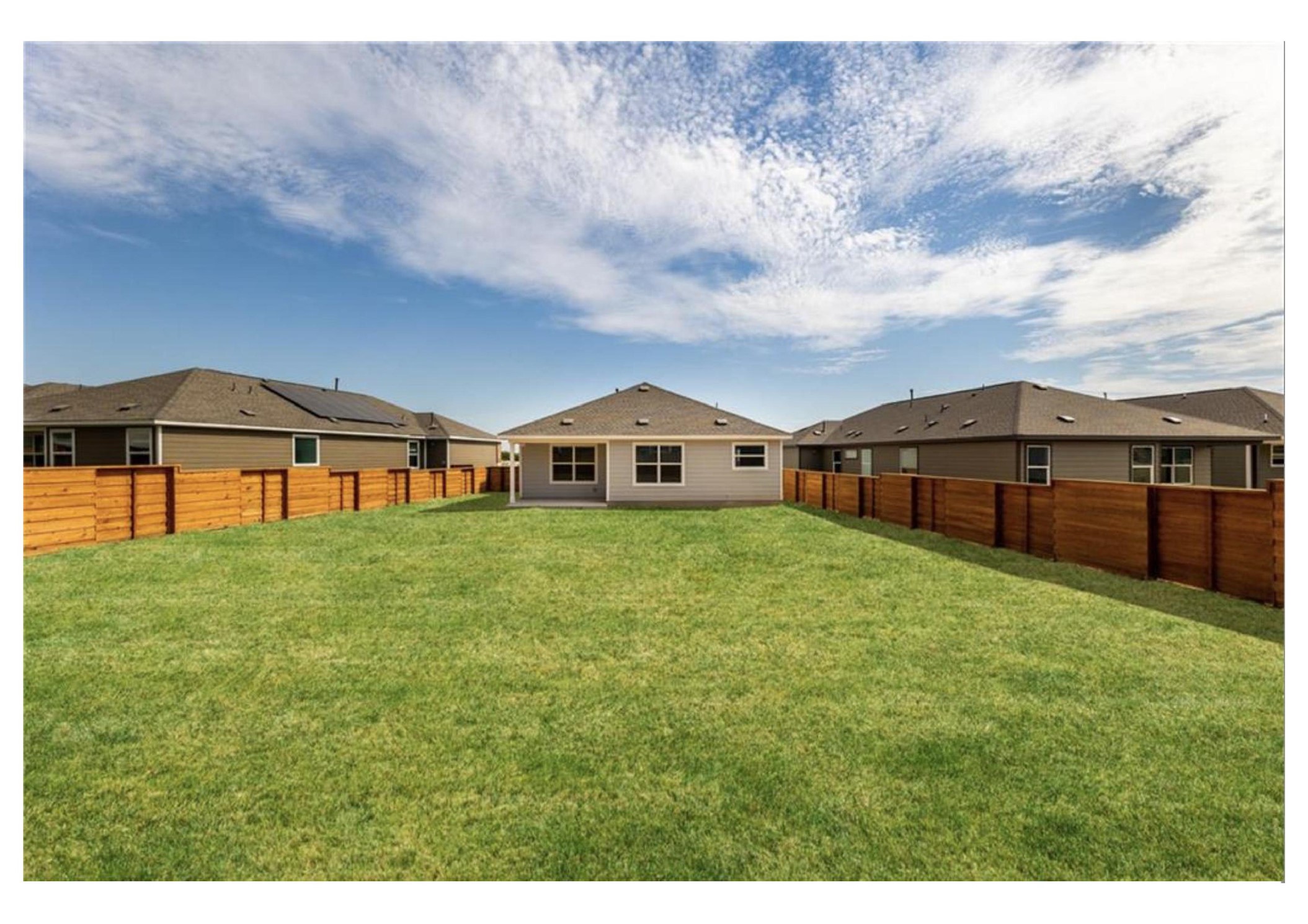 381 Jack Ryan Kyle, TX 78640 - Photo 24 of 25 A fenced backyard offers ample space and a clear view of the home's rear exterior.