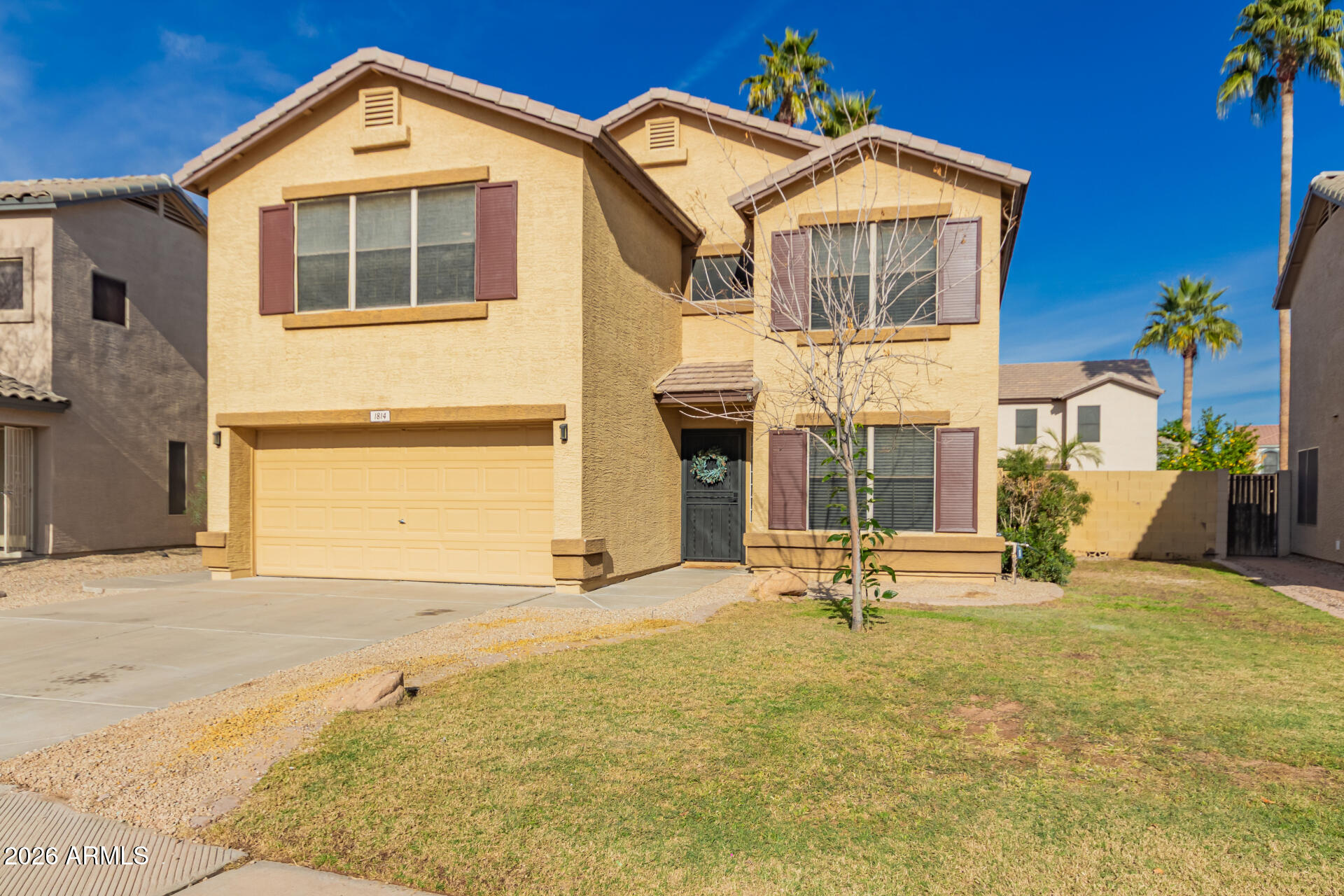 1814 East Milky Way Gilbert, AZ 85295 - Photo 2 of 28 a front view of a house with a yard