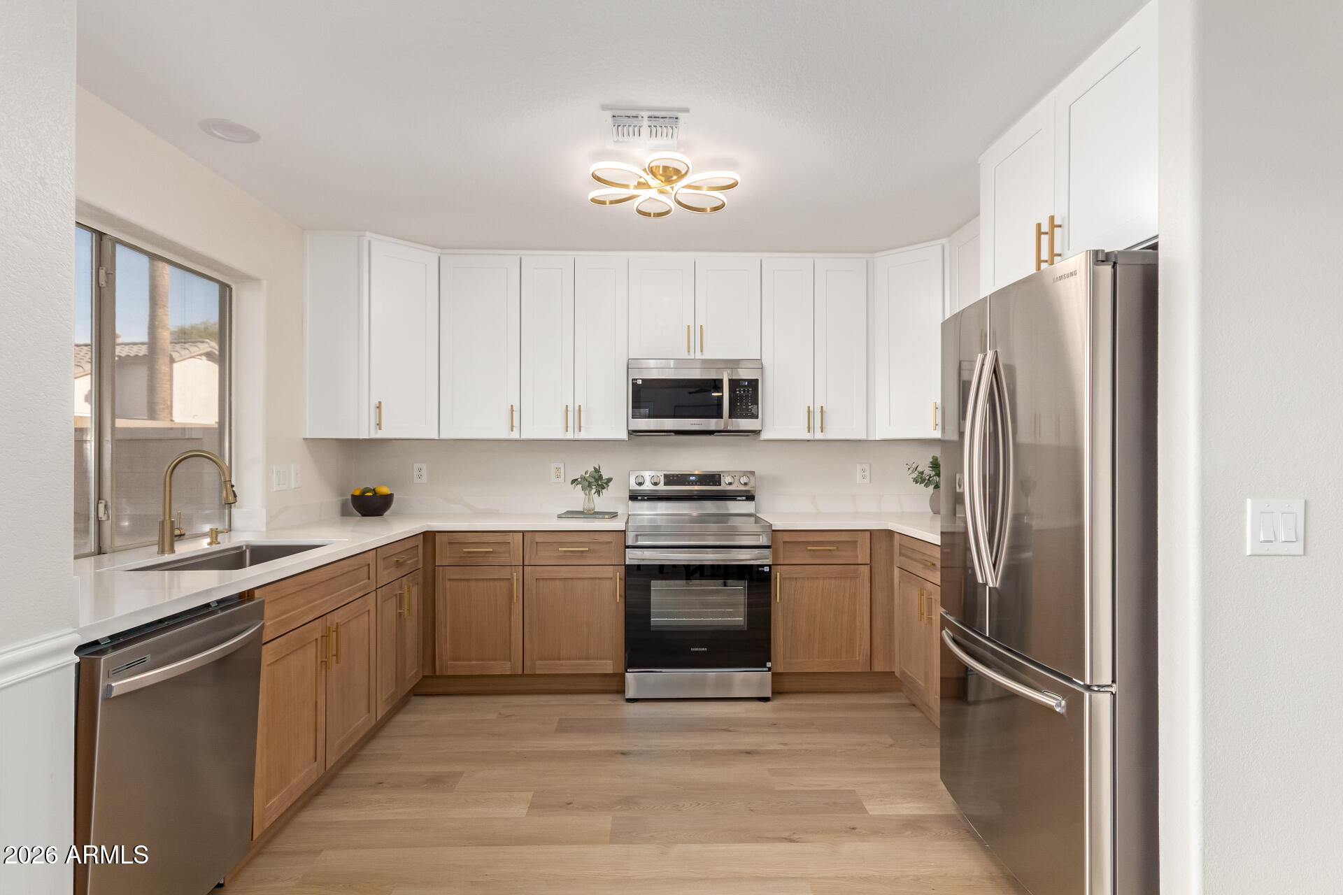 1814 East Milky Way Gilbert, AZ 85295 - Photo 9 of 28 a kitchen with stainless steel appliances granite countertop a refrigerator and a stove top oven