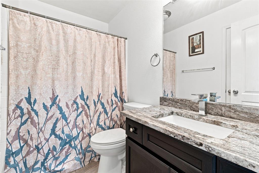 10409 Condor Loop Waco, TX 76708 - Photo 21 of 26 Vanity with a rectangular undermount sink, stone countertop, and chrome faucet