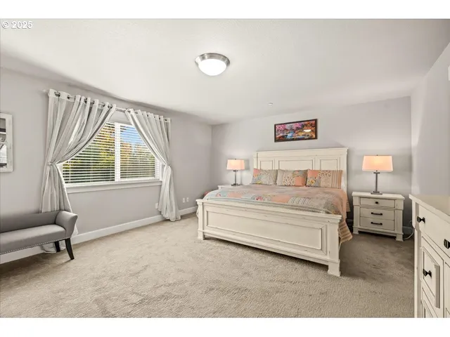a spacious bedroom with a bed and a large window