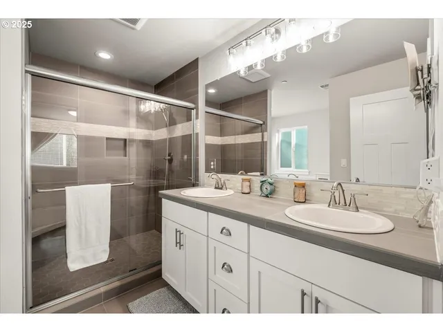 a bathroom with a sink a mirror and a shower