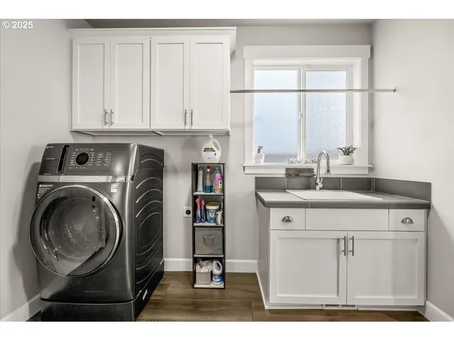 a kitchen with a sink cabinets and a large window