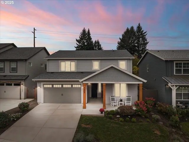 a front view of a house with a garden and yard