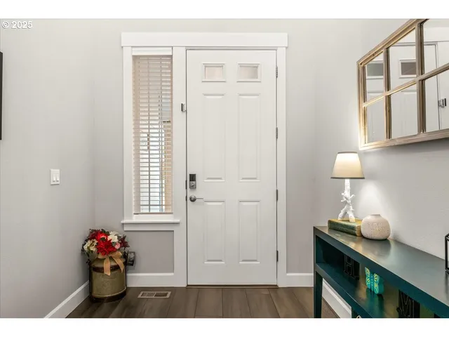 a hallway with cabinet and potted plant