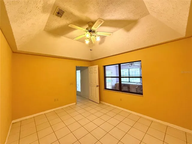a room with pool table and windows
