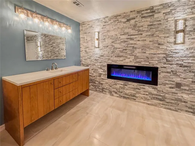 a spacious bathroom with a double vanity sink mirror and toilet