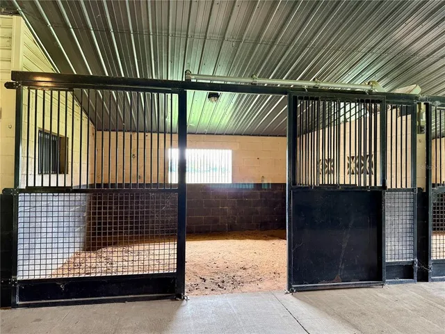a view of hallway with wooden floor and fence