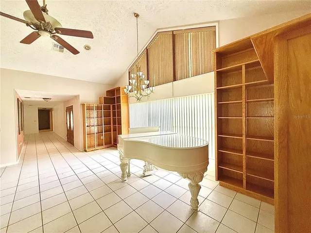 a view of an empty room with window and fire place