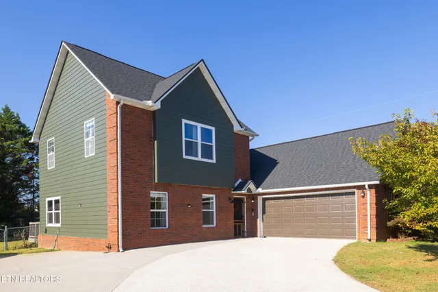 a front view of a house with garage