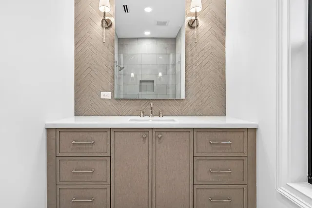 a bathroom with a sink and mirror