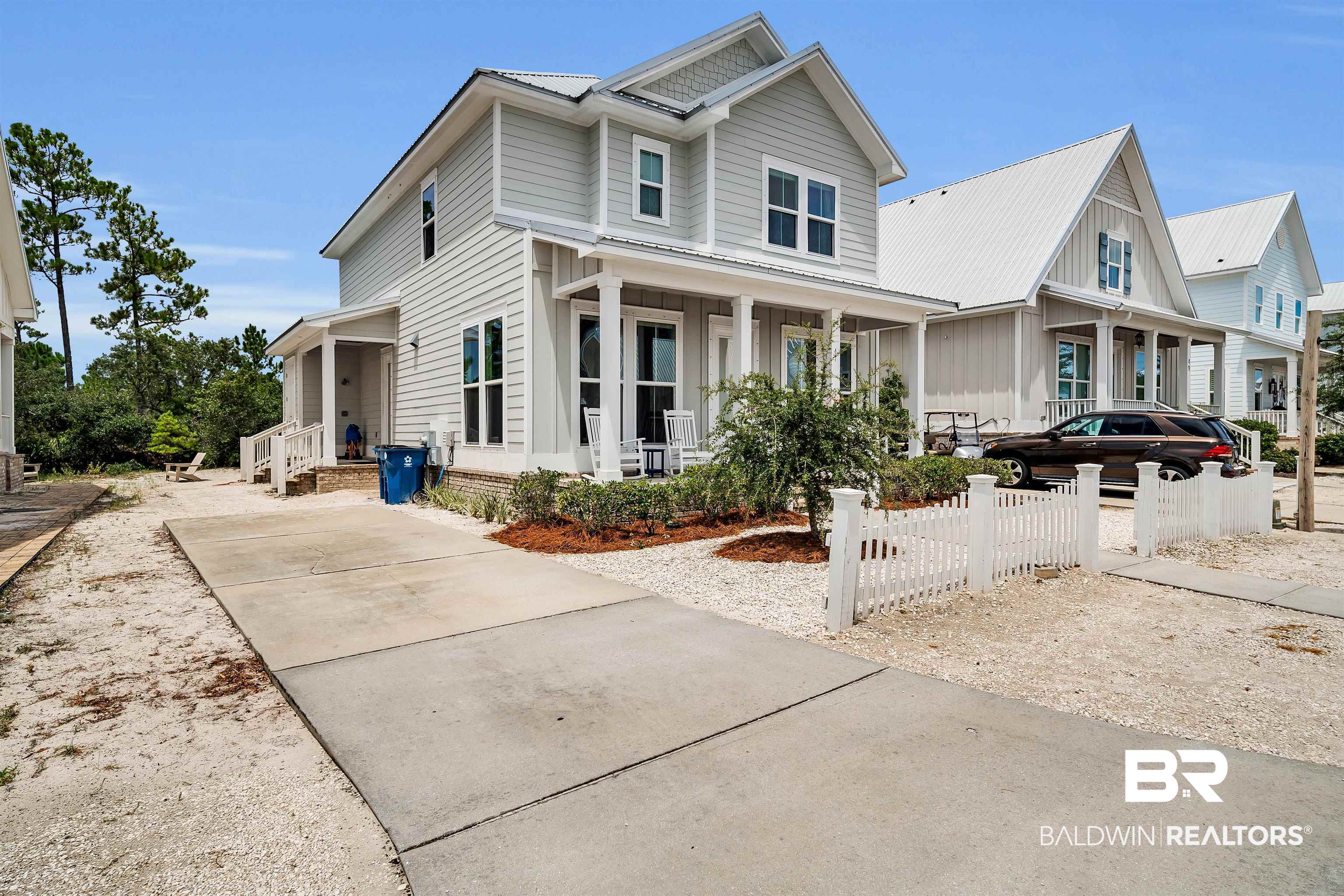 47 Parks Edge Orange Beach, AL 36561 - Photo 34 of 40 View of front of house featuring a porch, a metal roof, board and batten siding, and a fenced front yard