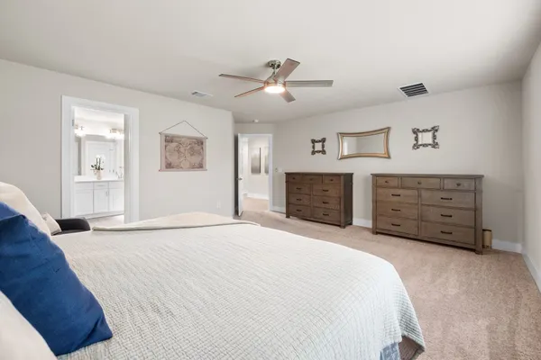 a spacious bedroom with a bed and a couch