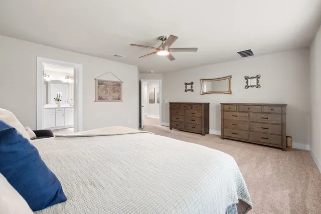 a spacious bedroom with a bed and a couch