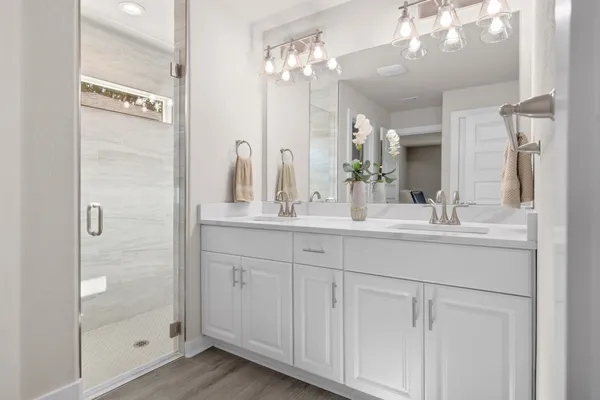 a spacious bedroom with a bed and a dresser