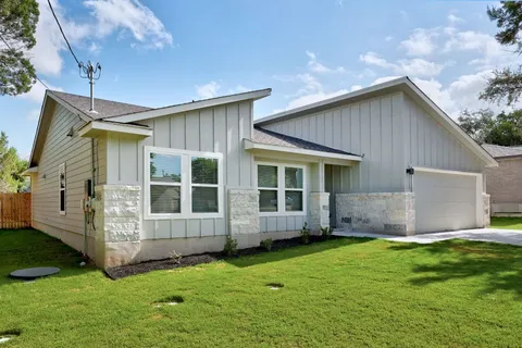 a view of house with backyard