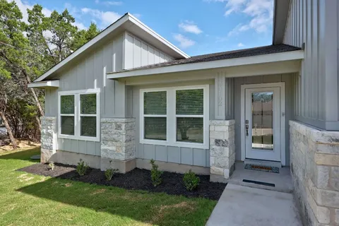 a front view of a house with a yard and porch