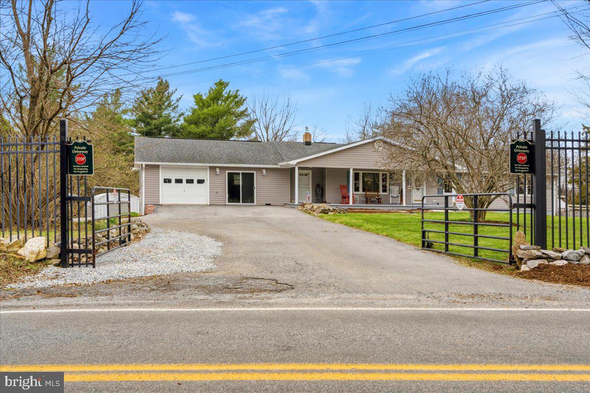18711 Burnside Bridge Road Sharpsburg, MD 21782 - Photo 3 of 9 a front view of a house with a garden and plants